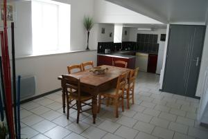 cocina con mesa de madera y sillas en Gite du coudray 85, en Saint-André-Goule-dʼOie