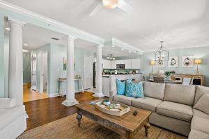 a living room with a couch and a table at The Preserve 202 in Blue Mountain Beach