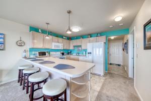 a kitchen with a large island with bar stools at Boardwalk Adventures in Long Beach