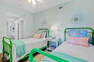 two beds in a room with blue walls at The Preserve 202 in Blue Mountain Beach +33 photos