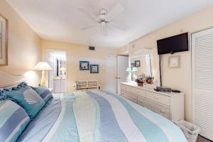 a bedroom with a large bed with a ceiling fan at Sea Colony - 109 Chesapeake House Rd in Sea Colony +39 photos