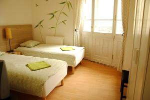 a hotel room with two beds and a window at Central Station Hostel in Warsaw