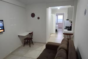 a living room with a couch and a table at Apartamento praia Natal in Natal
