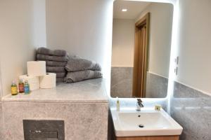 a bathroom with a sink and a mirror and towels at Luxurious Zed park tower pearl in Sheikh Zayed +60 photos