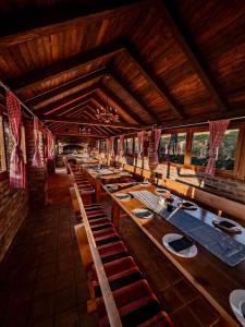 a dining room with wooden tables in a building at Sky Resort in Gunjavci