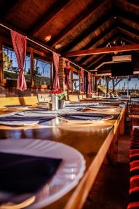 a row of tables with plates and napkins on them at Sky Resort in Gunjavci +21 photos