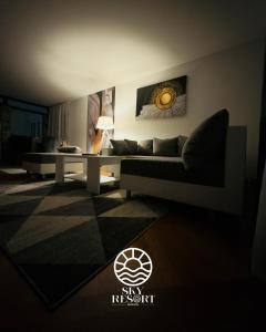 a living room with a couch and a table at Sky Resort 