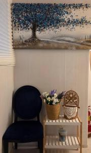 a blue chair sitting next to a painting on a wall at 블레싱하우스 in Seoul