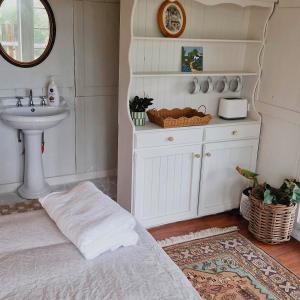 a bathroom with a bed and a sink and a sink at Tiny home mountain view in Ocean View