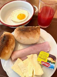 a plate of food with an egg and bread and cheese at Hostal Antonella in Los Ángeles
