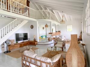 a living room with a couch and a table at Villa Cameo in Le Gosier