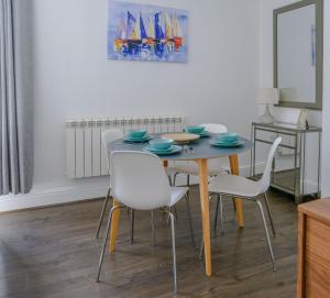 a dining room with a table and chairs and a painting at Cathedral view in Lichfield