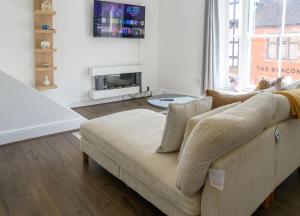 a living room with a couch and a tv at Cathedral view in Lichfield