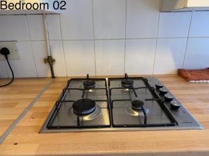 a stove top oven sitting on top of a kitchen floor at 5 Brunswick St - Bedroom 02 downstairs in Bristol +8 photos