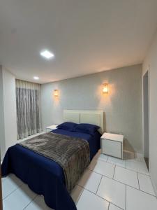 Ένα ή περισσότερα κρεβάτια σε δωμάτιο στο Aconchegante apartamento a 100 mt da Praia da Bacutia