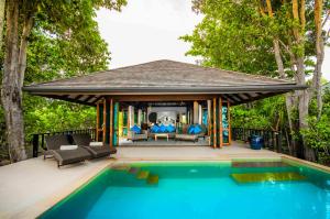 a house with a swimming pool and a gazebo at Koh Jum Beach Villas "A member of Secret Retreats" in Ko Jum