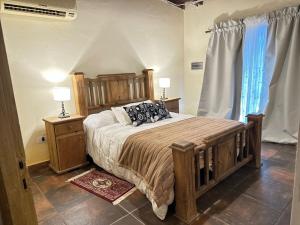 a bedroom with a large bed and two night stands at Refugio exclusivo entre Viñedos y Cordillera in Ciudad Lujan de Cuyo