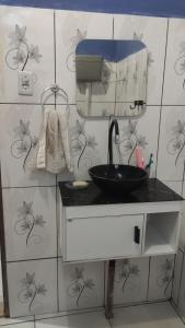 a bathroom with a sink and a mirror at Família Marcon in Belém +7 photos
