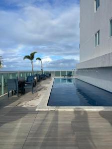 Bazén v ubytování Conforto beira mar Flamboyant nebo v jeho okolí