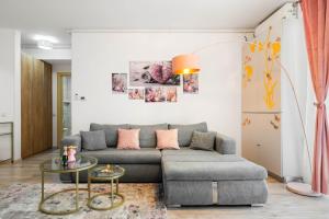 a living room with a couch and a table at Moonlight Flower in Mamaia +34 photos