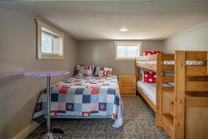 a bedroom with a bed and a bunk bed at Blue Water Bungalows in Milford