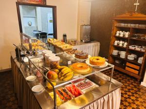 a buffet line with many different types of food at Hotel Ponta Grossa São Marcos in Ponta Grossa