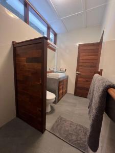 a bathroom with a toilet and a sink at Pondok Asri in Mangsit +28 photos