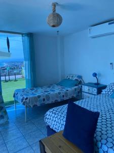 a bedroom with two beds and a blue light at Habitación privada in Crucita