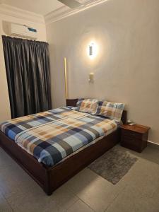 a bedroom with a bed with a plaid at Idg-Residence in Cotonou