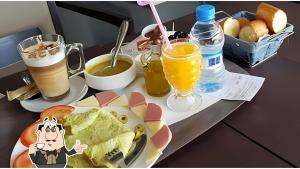 a table with a plate of food and drinks at Hotel Rherssllah 
