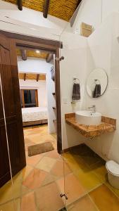 a bathroom with a sink and a bed in a room at Rivera Campestre in Tinjacá +53 photos