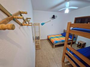 a room with a bunk bed and a ladder at A Ver o Mar Guest House in Caraguatatuba +63 photos