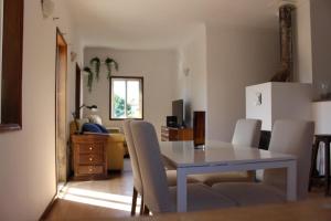 a dining table and chairs in a living room at Oporto- Lousada- Casa da Prêsa in Lousada