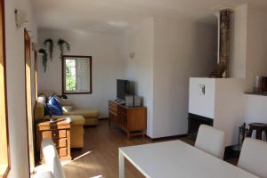 a living room with a couch and a refrigerator at Oporto- Lousada- Casa da Prêsa in Lousada