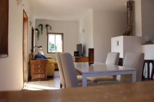 a dining table and chairs in a living room at Oporto- Lousada- Casa da Prêsa in Lousada