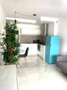 a kitchen with a blue refrigerator and a table at Apartamento Maresía in Candelaria +12 photos