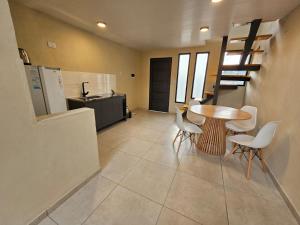 a kitchen and dining room with a table and chairs at Loft Sp in San Pedro