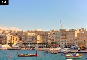 a group of boats in a harbor with buildings at Senglea Apartments, Triq il-Kurcifiss, L-Isla in Senglea +17 photos