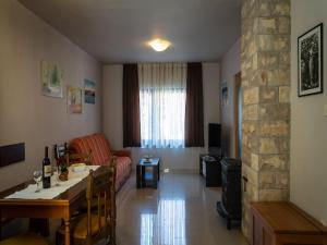 a living room with a couch and a table and a living room with a fireplace at Green Area Apartments Krem ar - GroundFloor Apartment With Terrace in Homer