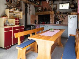 a kitchen with a wooden table and a refrigerator at Green Area Apartments Krem ar - GroundFloor Apartment With Terrace in Homer