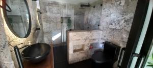 a bathroom with a sink and a mirror at Villas Julieta in El Peñol +116 photos