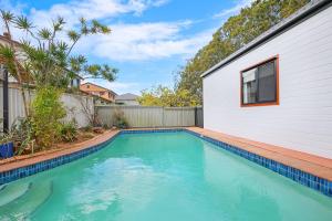 une piscine à côté d'une maison avec une clôture dans l'établissement The Terrarena - Family Stay near Shopping & Eateries, à Brisbane