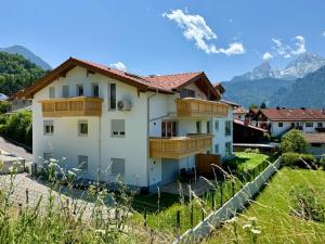 a house on a hill with mountains in the background at Neubau, Bergpanorama, gute Lage, Tiefgarage in Berchtesgaden