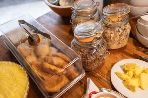 a wooden table topped with jars of food and nuts at Hotel Isla del Sol in Isla Grande +74 photos