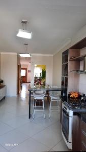a kitchen with a table and chairs in a room at ZL Brasil in São Paulo