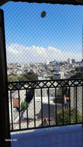 a view of a city through a chain link fence at ZL Brasil in São Paulo