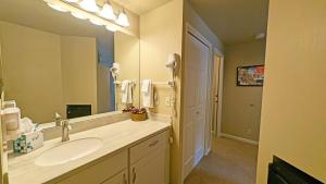a bathroom with a sink and a large mirror at River Ridge 423B condo in Bend