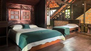 a bedroom with two beds in a room at Casa Bem-Te-Vi | Alter do Chão in Alter do Chao