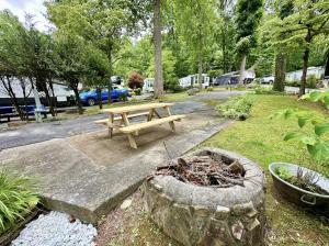 a park with a picnic table and a bench at Crofty Bear - Empty RV Camping Lot in Gatlinburg in Gatlinburg