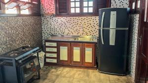a kitchen with a refrigerator and a sink in it at Casa Bem-Te-Vi | Alter do Chão in Alter do Chao +9 photos